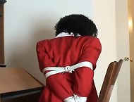 Curly haired slave Violet getting tied up on the chair in the office